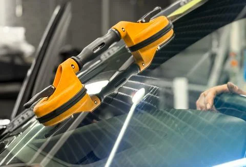 Automobile special workers replacing windscreen or windshield of a car. Stock Photos