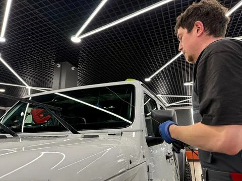 Automobile special workers replacing windscreen or windshield of a car. Stock Photos