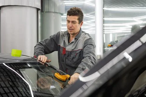 Automobile special workers replacing windscreen or windshield of a car. Stock Photos
