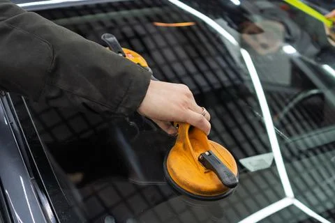 Automobile special workers replacing windscreen or windshield of a car. 写真素材