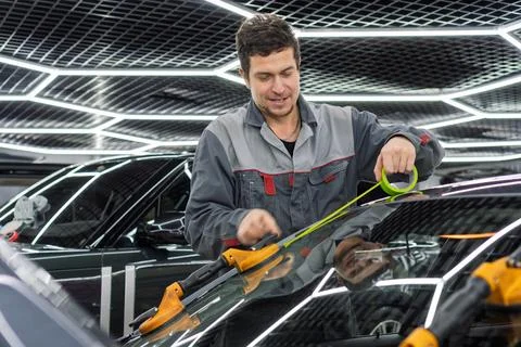 Automobile special workers replacing windscreen or windshield of a car. 写真素材