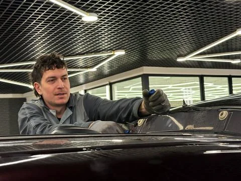 Automobile special workers replacing windscreen or windshield of a car. Stock Photos
