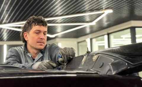 Automobile special workers replacing windscreen or windshield of a car. Stock Photos
