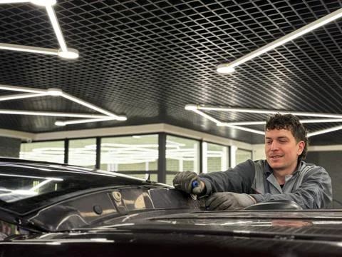 Automobile special workers replacing windscreen or windshield of a car. Stock Photos