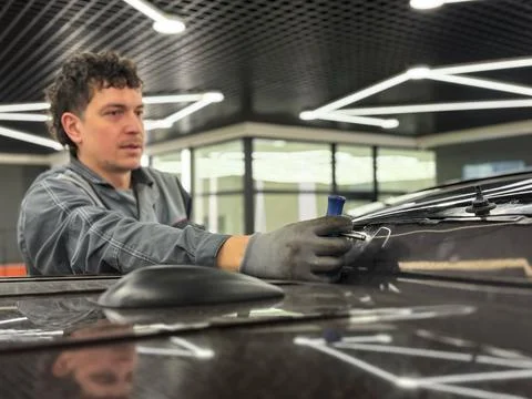 Automobile special workers replacing windscreen or windshield of a car. Stock Photos