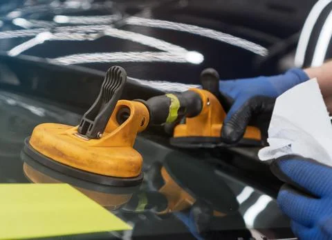 Automobile special workers replacing windscreen or windshield of a car in a.. Stock Photos