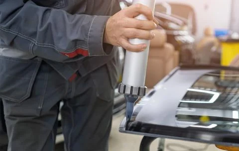 Automobile special workers replacing windshield of a car. 写真素材