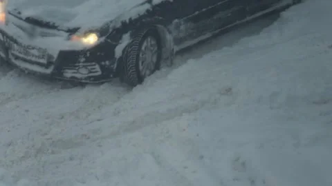 Automobile wheel spinning vigorously in deep winter snow, vehicle stuck on Stock Footage 344864993
