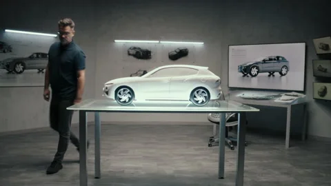 Automotive engineer develops a prototype model car in a modern studio of company Video stock 219448764