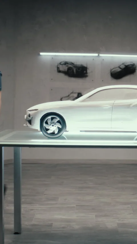 Automotive engineer develops a prototype model car in a modern studio of company 動画素材 276154478