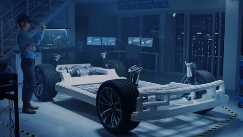 Automotive Engineer Working on Electric Car Chassis Platform, Using AR Headset Stock Footage 105725612