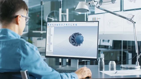 Automotive Engineer Working on a Personal Computer  He's Designing New Engine. Stock Footage 83796548