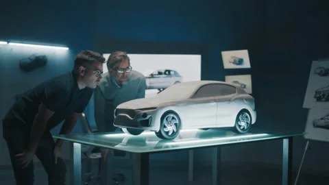 Automotive engineers work with concept car model prototype in a high tech office Stock Footage 219449717