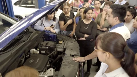 Automotive Instructor Teaching Vehicle Engine Inspection During Workshop Stock Footage 336466379