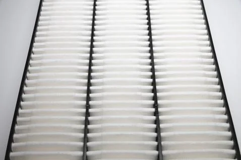 Automotive internal combustion engine filter close-up. Detail of a new car part Stock Photos