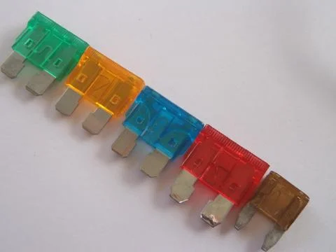 Automotive multi coloured different sized plastic blade plug spade car fuses Stock Photos