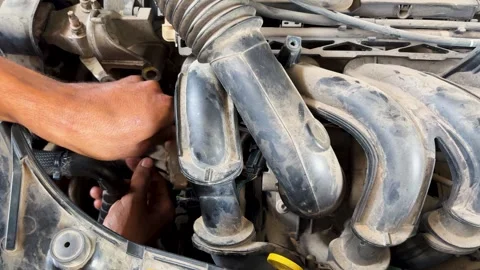 Automotive technician servicing engine bay during scheduled vehicle maintenance Stock Footage 340955208