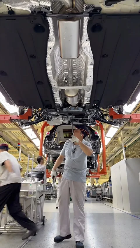 Automotive Workers Assembling Car Undercarriage on Production Line, China Stock-Footage 336763502