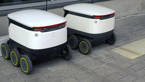 Autonomous Delivery Robots Recharging at a Charging Station Outdoors Stock Footage 336537639