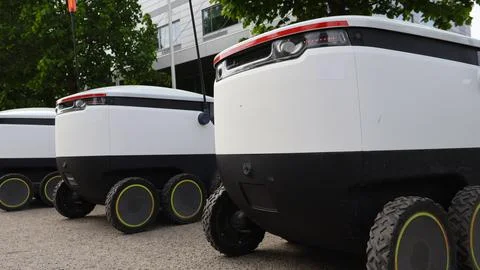Autonomous Delivery Robots Standing By For Service Stock Photos