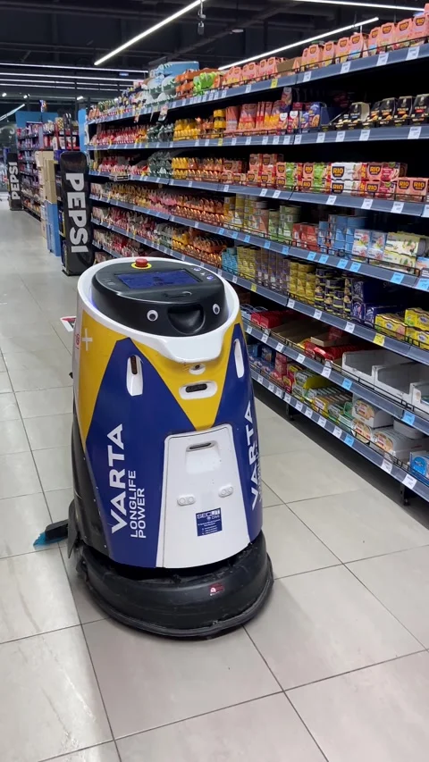 Autonomous floor cleaning robot operating in a supermarket Stock Footage 326191000