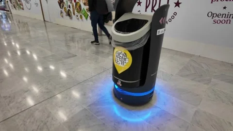 Autonomous garbage robot cleaning Paris Charles de Gaulle Airport terminal Stock Footage 327158304