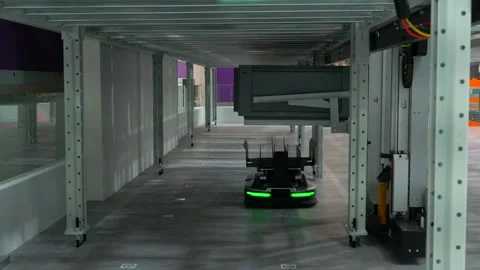 Autonomous lowprofile shuttle robot navigates under racking system in smart Stock Footage 311691187