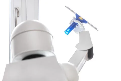 A autonomous robot is washing a window 库存照片