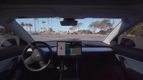 Autonomous Tesla EV car in full self driving autopilot mode Stock Footage 118693382