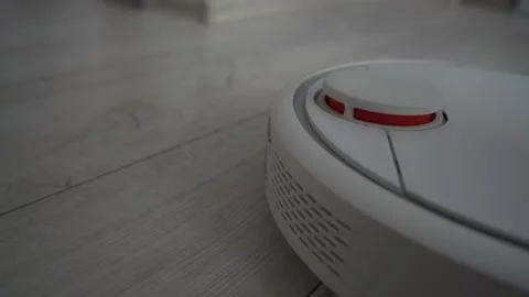 Autonomous wireless robotic vacuum cleaner working on wooden floor Stock Footage 180638338