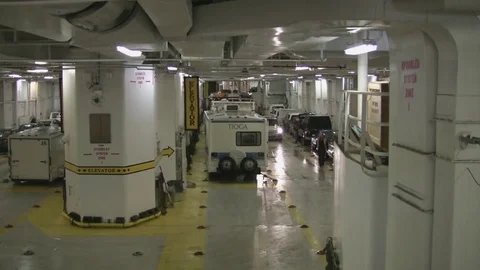 Autos find parking space in cavernous parking area at bottom of Alaskan ferry. Stock Footage 79410058