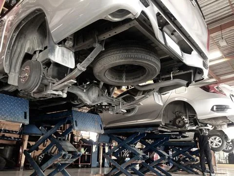 Autos in the process of changing wheels on the car lifts. Stock Photos