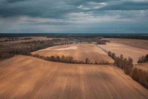 Autumn agricultural fields under dramatic sky with clouds Stock Photos