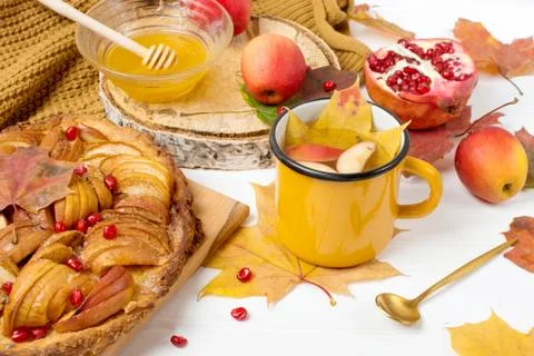 Autumn apple pie, place for text, mug with autumn tea, pomegranate Stock Photos