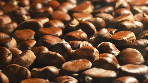 Autumn background with chestnuts. Full frame of edible chestnuts. Stock Photos