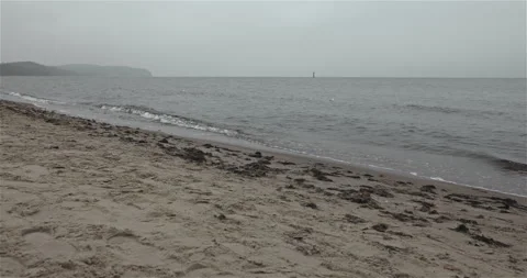 Autumn Beach with Cliffs on the Horizon Stock Footage 297579658