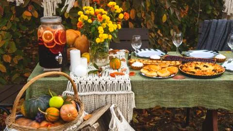 Autumn brunch table in the backyard with pumpkin and yellow decor. Stock Photos