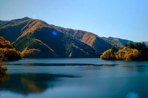 Autumn-colored mountain reflected in deep blue lake — Tokyo, December Stock Photos