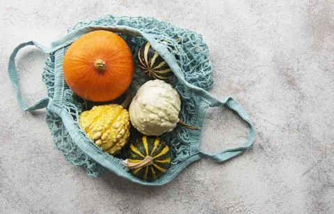 Autumn composition with assorted pumpkins in eco string bag Foto stock