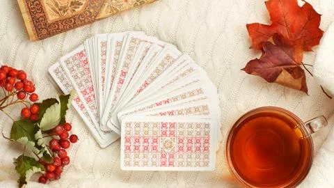 Autumn composition with cup of tea maple leaves and tarot cards Stock Photos