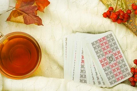 Autumn composition with cup of tea maple leaves and tarot cards Stock Photos