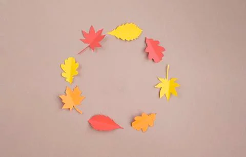 Autumn composition. Frame is made of paper autumn leaves on a beige backgroun Stock Photos