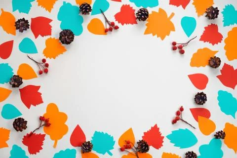 Autumn composition frame Paper colored leaves cones branches berries on white Stock Photos