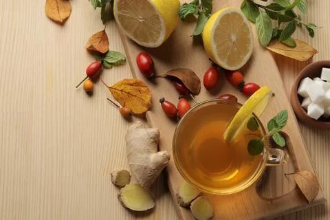 Autumn composition with hot tea with ginger and lemon on a natural wooden tab Stock Photos