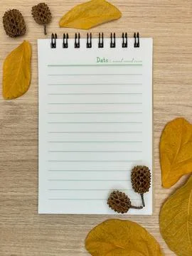 Autumn composition with a notebook, leaves and natural decor Stock Photos