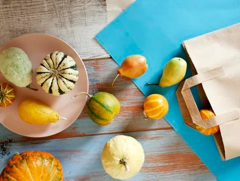 Autumn composition of pumpkins of different varieties, cupcakes, pears Stock Photos