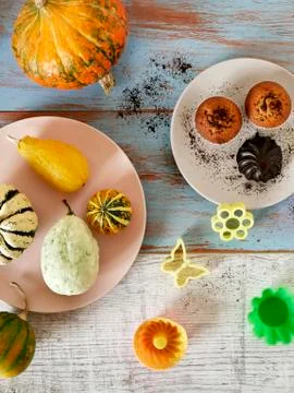 Autumn composition of pumpkins of different varieties, cupcakes, pears Stock Photos