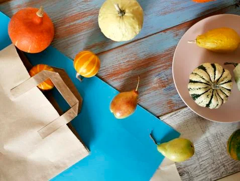 Autumn composition of pumpkins of different varieties, cupcakes, pears Stock Photos