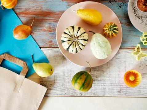 Autumn composition of pumpkins of different varieties, cupcakes, pears Stock Photos