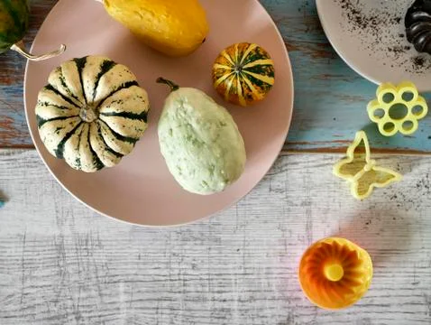Autumn composition of pumpkins of different varieties, cupcakes, pears Stock Photos